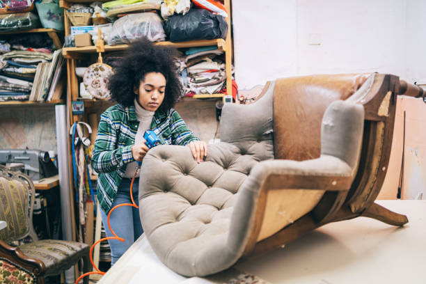 Afro Female Small Business Owner Refurbishing Chair In Upholstery Workshop